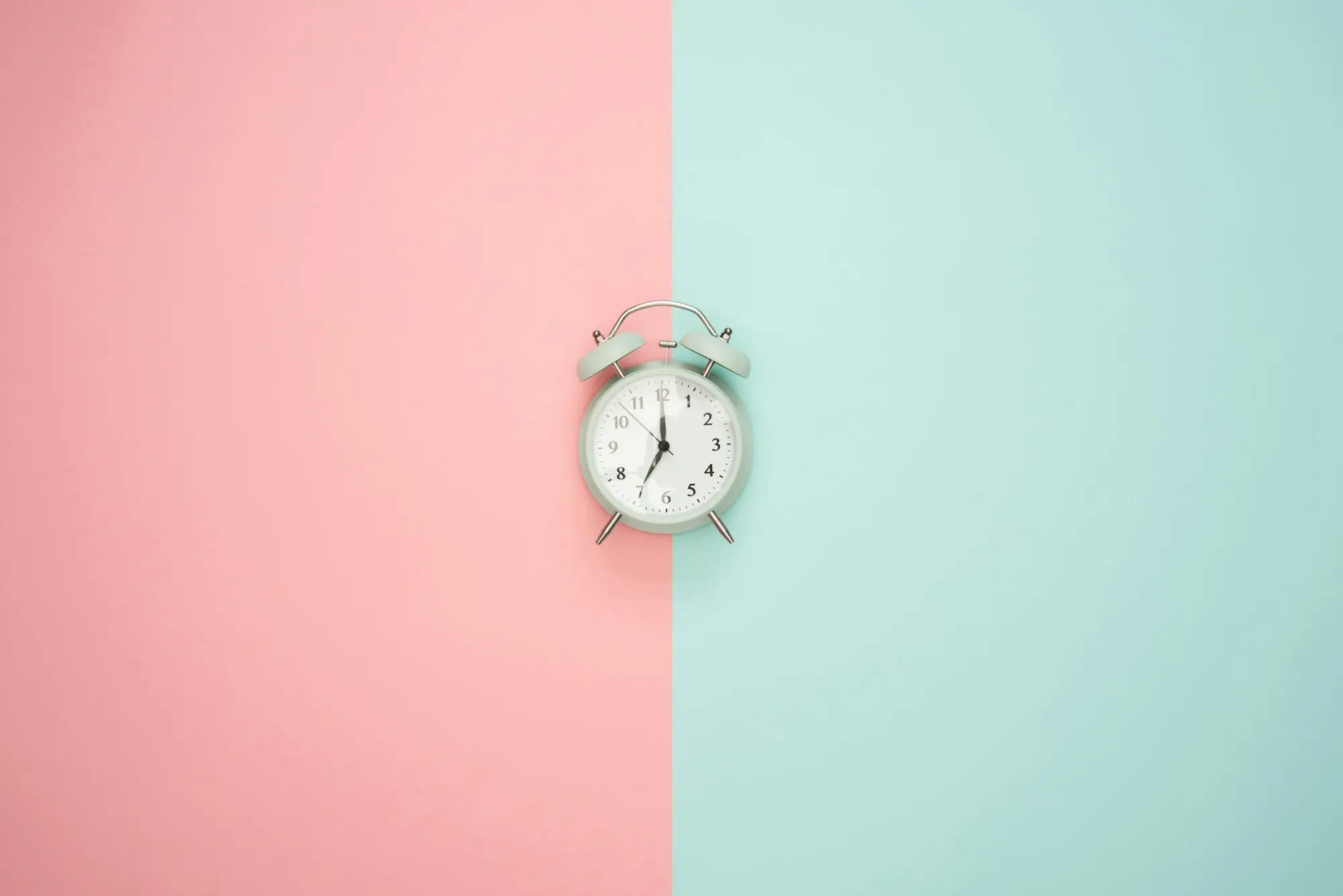 Silver bell alarm clock on a desk, a reminder of a funding deadline