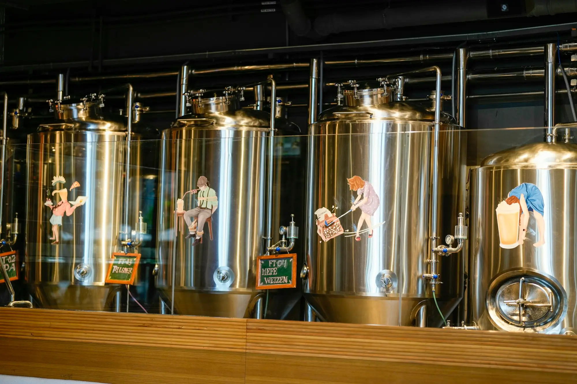 Stainless steel fermentation tanks inside a craft brewery