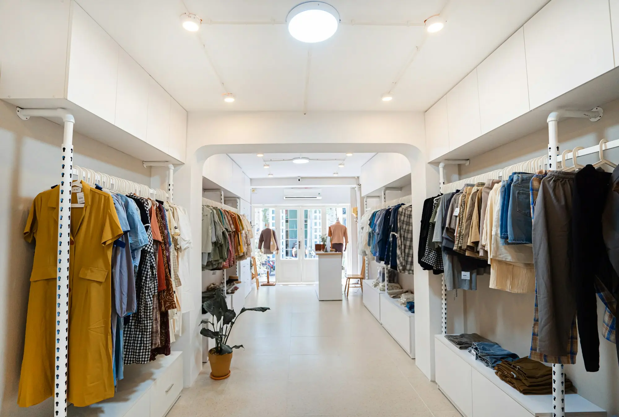 Clothes hanging on a rack in a retail store, stock ready to sell