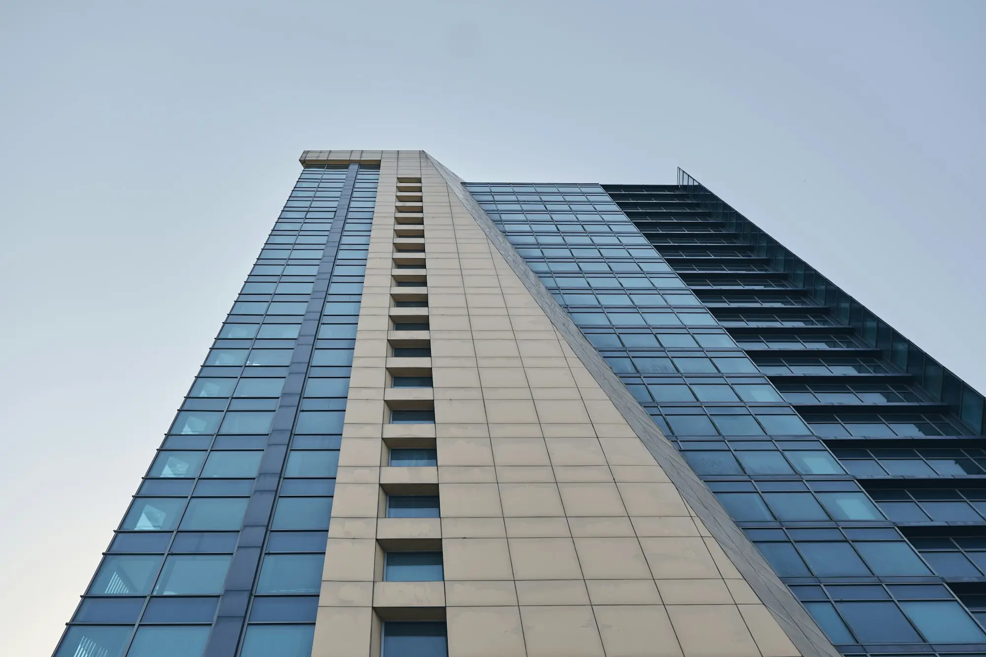 White and brown commercial building against a blue sky