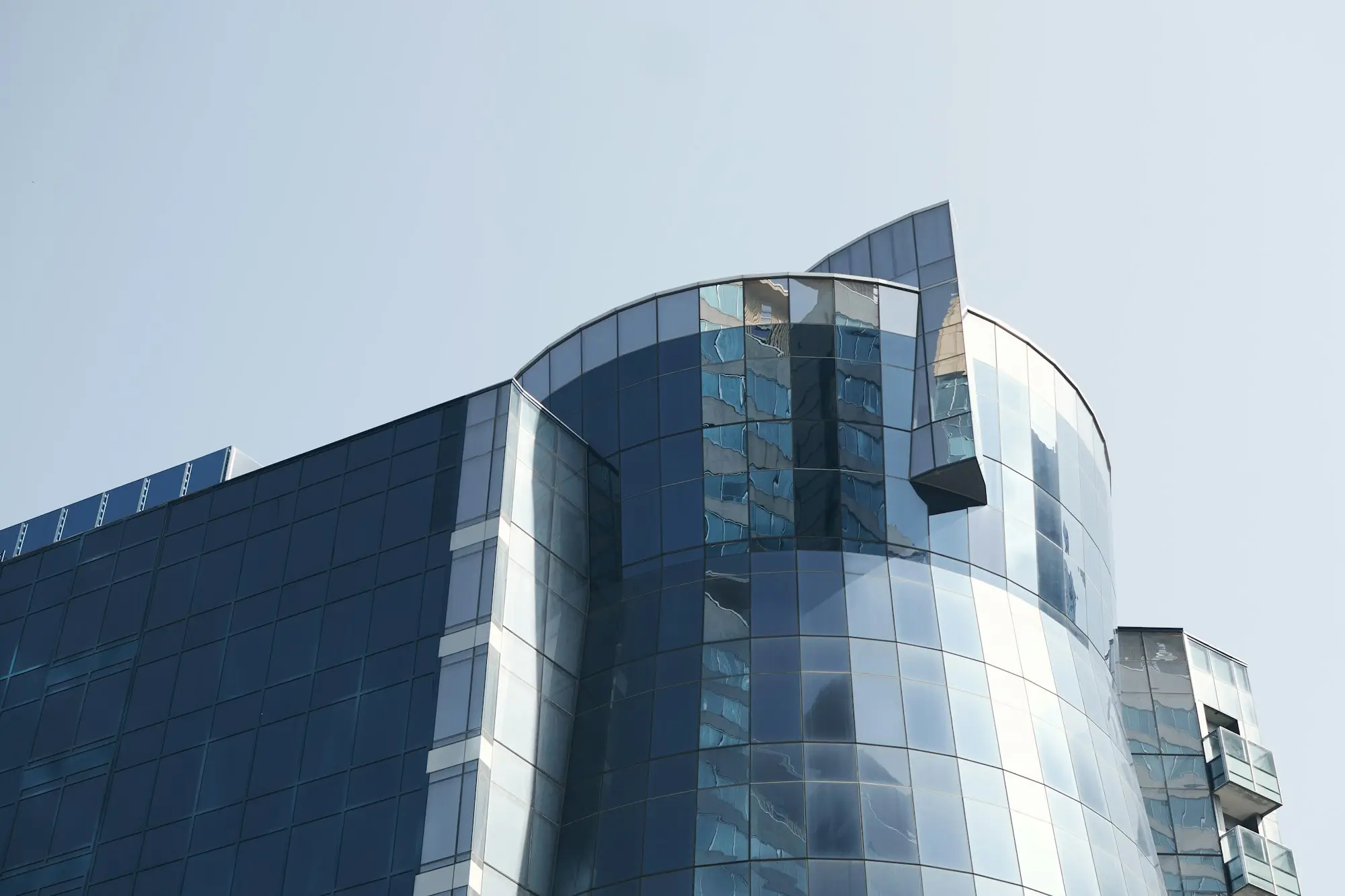 Blue glass office tower seen from street level