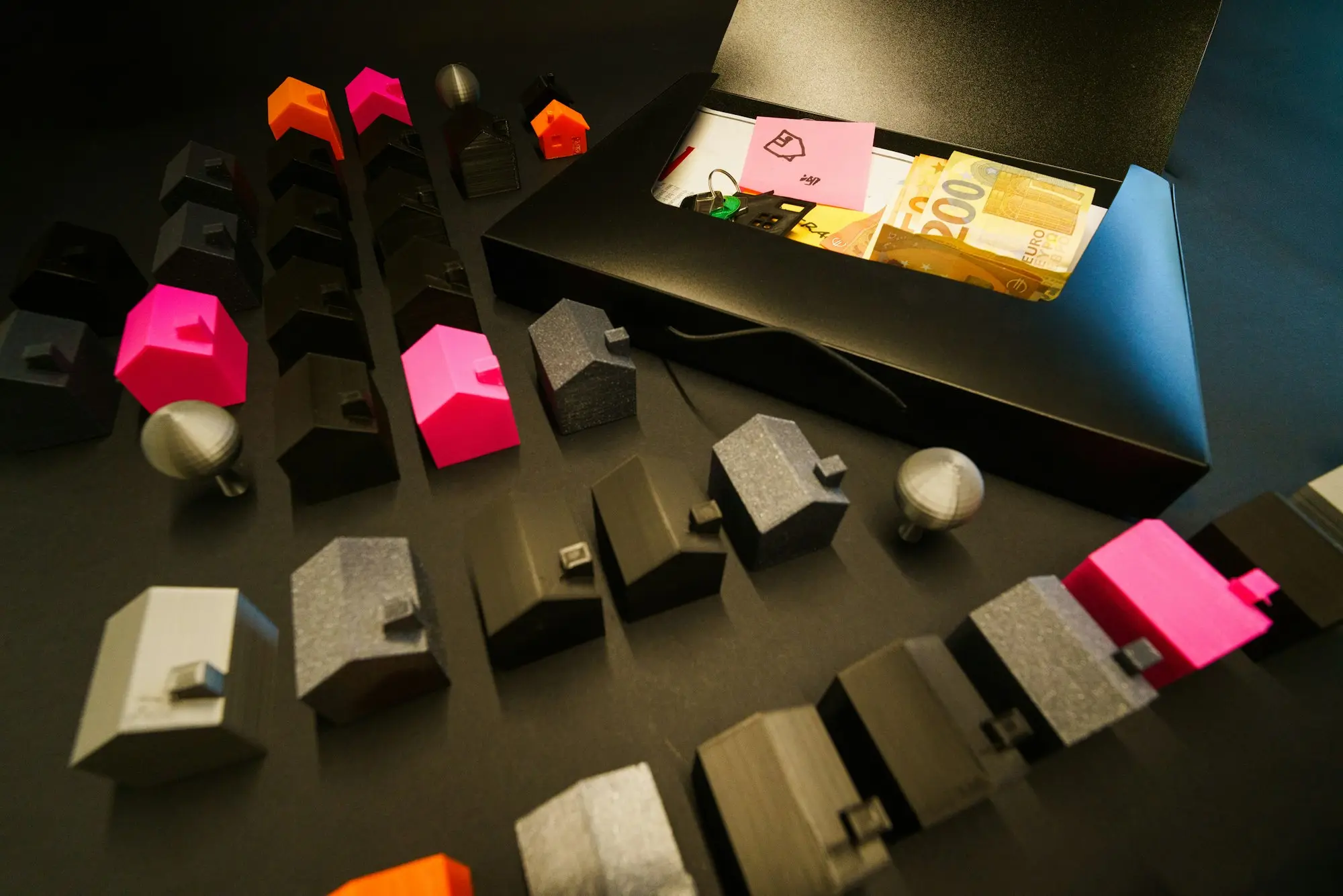 Miniature model houses arranged in an open box, representing property equity
