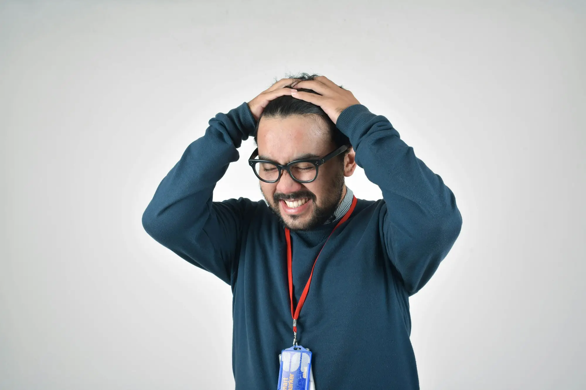 Business owner in a blue sweater thinking through his options